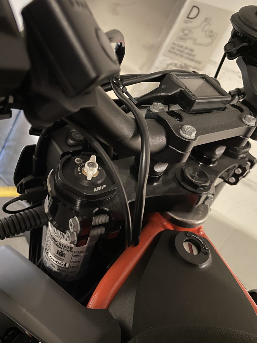 The finished mount installed on the motorcycle handlebar